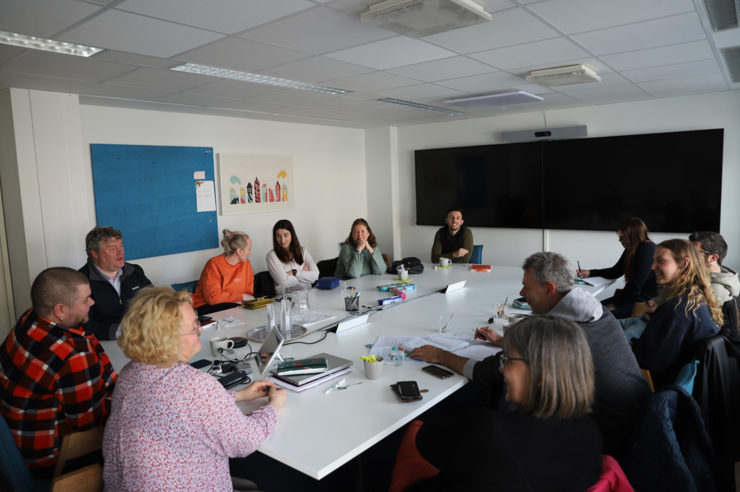 Projektiin osallistuvat työntekijät keskustelevat ison pöydän ääressä Y-Säätiön toimistolla Helsingissä.